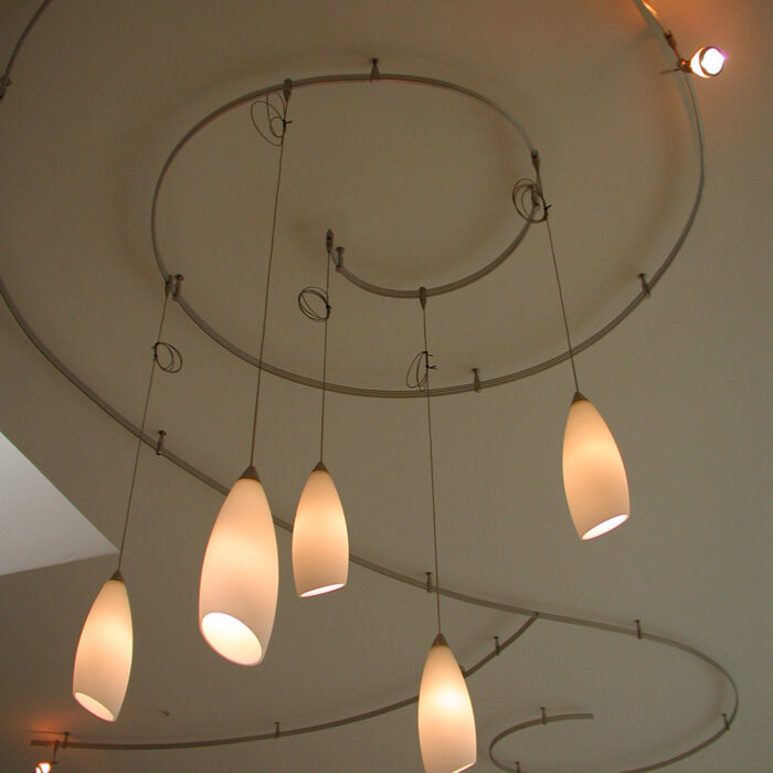 an image of an interior lighting installation of curly lights on a ceiling