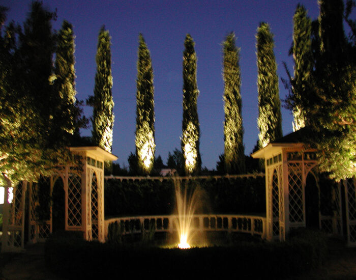 an image of a fountain illuminated at night