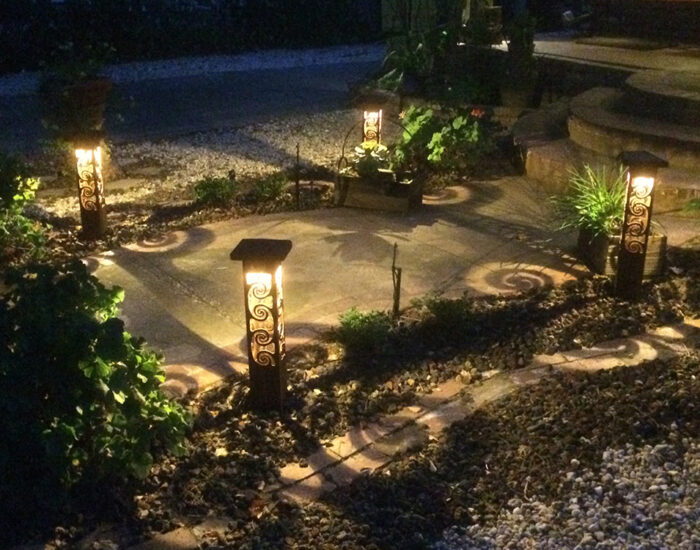 Sidewalk lighting with cool swirl shadows