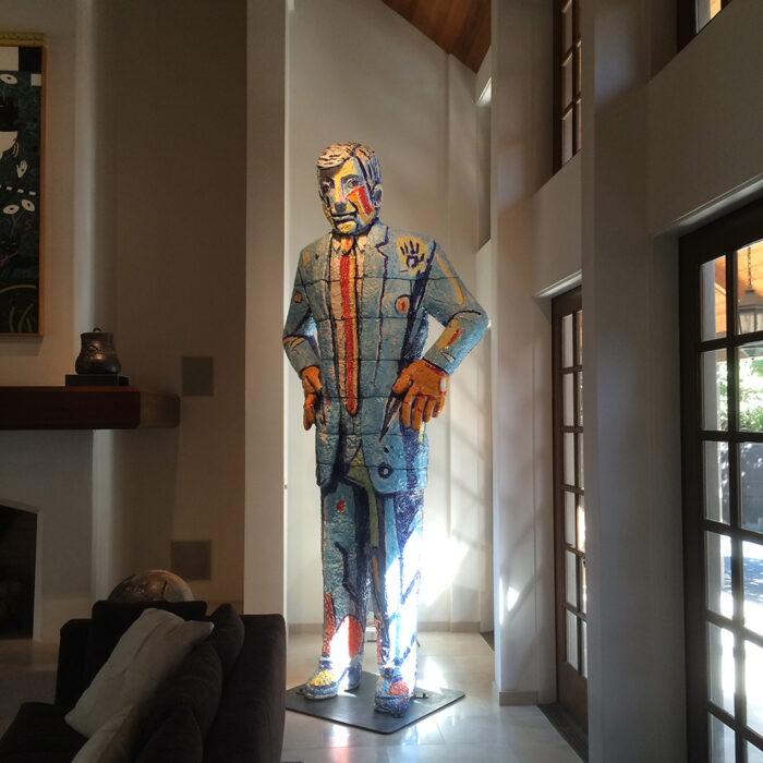 an image of a suited man sculpture with strategic lighting around it