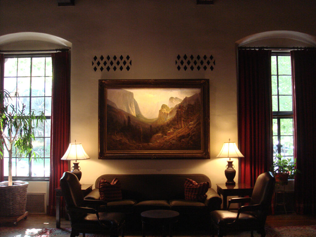 an image of a seating area in the Sutter Club Library Room with lamps illuminating the scene